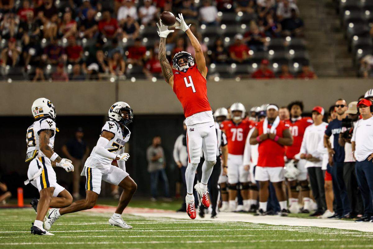 Oct 26, 2024; Tucson, Arizona, USA; Arizona Wildcats wide receiver Tetairoa McMillan (4) attempts to catch the ball during the third quarter against the West Virginia Mountaineers at Arizona Stadium. Mandatory Credit: Aryanna Frank-Imagn Images