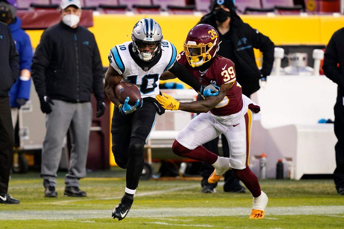 Carolina Panthers wide receiver Curtis Samuel (10) runs with the ball as he is chased by Washington Football Team defensive back Jeremy Reaves (39) during the first half of an NFL football game, Sunday, Dec. 27, 2020, in Landover, Md. (AP Photo/Susan Walsh)