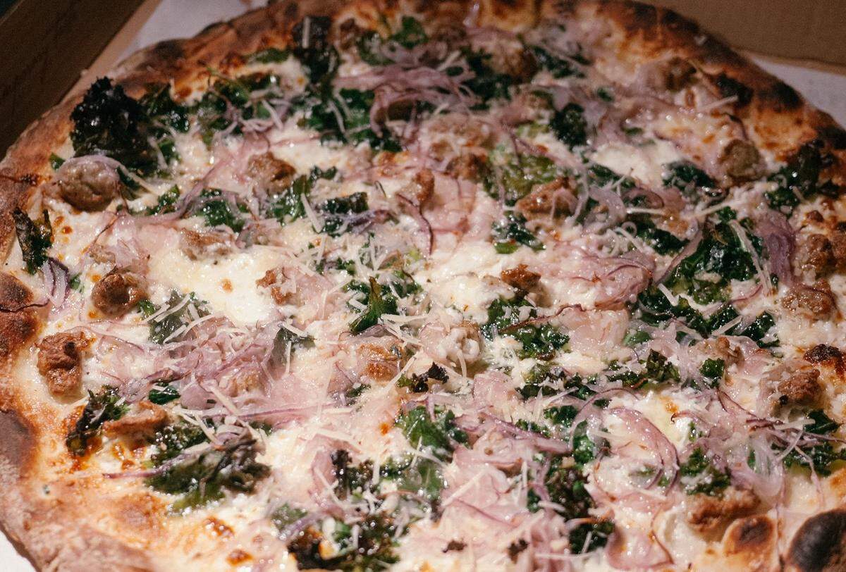 Bird Pizzeria’s White Pie with sausage, mushrooms, onions and kale.