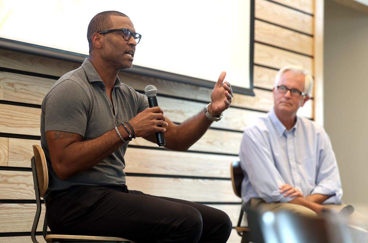 Former Carolina Panthers defensive end Mike Rucker, left, talks about his career and the current team as Charlotte Observer sports columnist Scott Fowler, right, looks on during The Charlotte Observer’s preview for the upcoming season on Monday, August 5, 2024 at Olde Mecklenburg Brewery & Biergarten in Ballantyne.