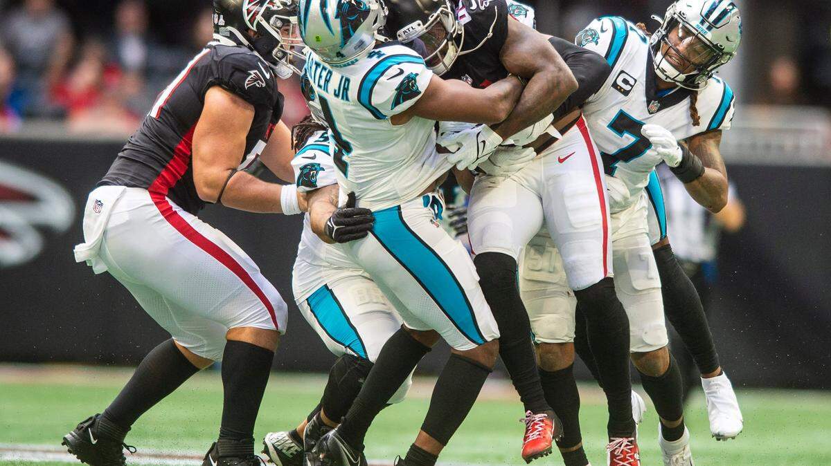 Panthers linebacker Jermaine Carter, Jr., second from left, tackles Falcons running back Cordarrelle Patterson during the game against the Falcons at Mercedes-Benz Stadium on Sunday, October 31, 2021 in Atlanta, GA.