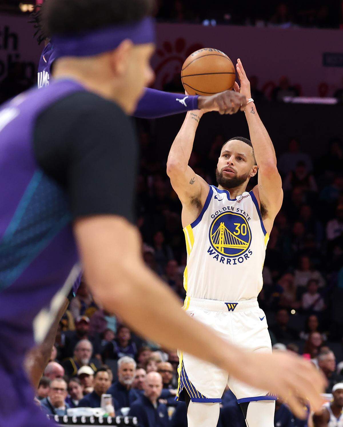 Golden State Warriors guard Steph Curry releases a three-point shot during action against the Charlotte Hornets at Spectrum Center in Charlotte, NC on Monday, March 3, 2025.