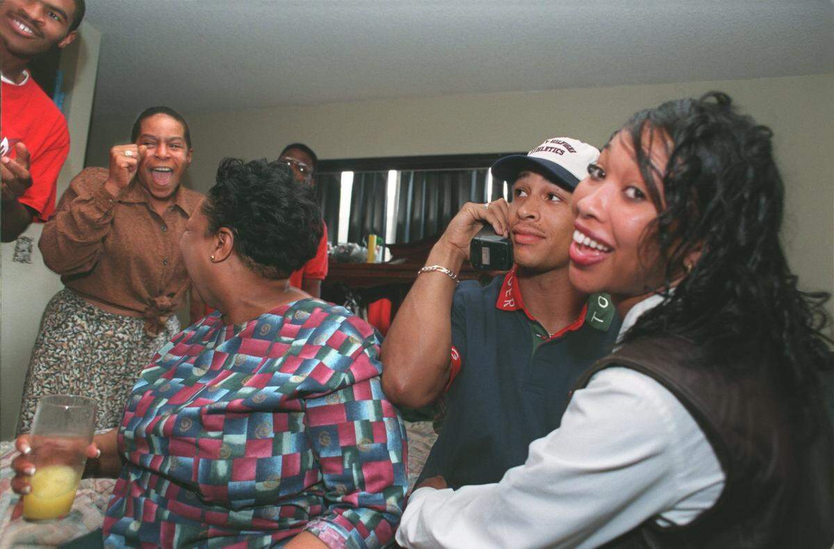 Rae Carruth (white cap) is embraced by his cousin Tiffany Adams (rt-age 23) after being selected by the Carolina Panthers with the teams 27th pick and second of the 1st round Saturday afternoon at his aunts home in South Sacramento. Carruth, the former standout at Valley High School and the University of Colorado was projected to be picked as high as seventh overall. photograph by Jose Luis Villegas 4/19/97