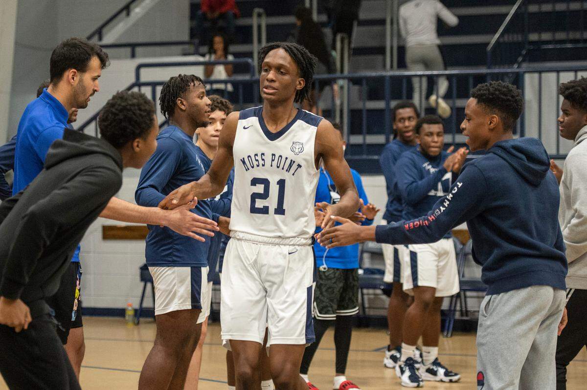 Moss Point forward Kedrick Osby high fives his teammates as he steps out onto the court before a game against Biloxi at Moss Point High School in Moss Point on Tuesday, Dec. 21, 2021.
