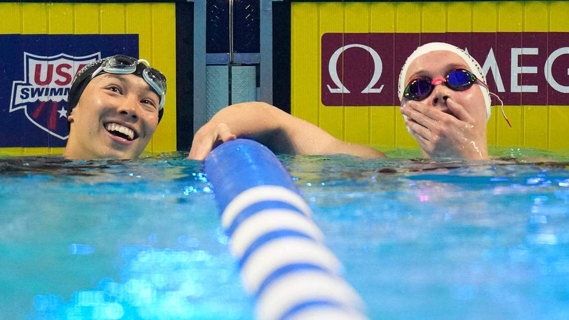 Torri Huske and Claire Curzan, right, check their times after competing in the women’s 100-meter Butterfly final of the U.S. Olympic Swim Trials on Monday in Omaha. Curzan, a high school student from Cary, N.C. qualified for the Olympic team with her finish.