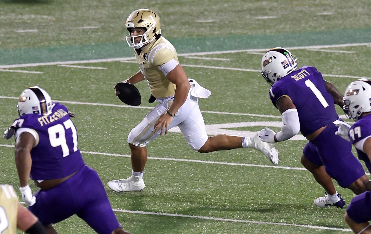 Charlotte 49ers quarterback Max Brown rushes out of the pocket for yardage during action against James Madison University on Saturday, August 31, 2024 at Jerry Richardson Stadium.