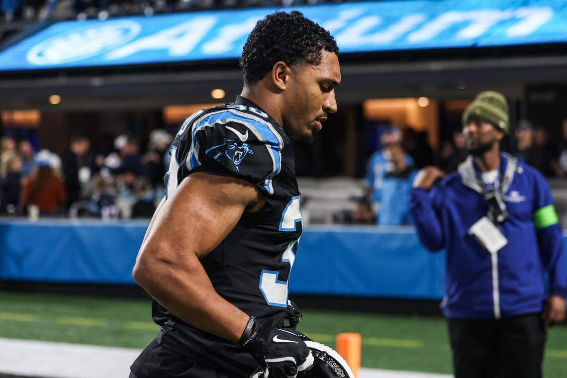 Panthers running back Chuba Hubbard runs to the locker room with his head down after a loss to the Rams, 34-31, after the the Wild Card playoff game at Bank of America Stadium in Charlotte on Saturday, January 10, 2026.