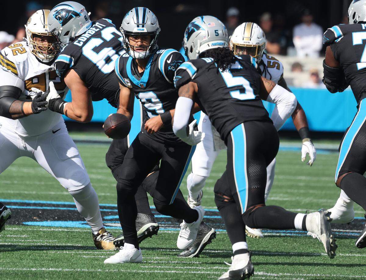 Carolina Panthers quarterback Bryce Young hands the ball to Rico Dowdle on Sunday, Nov. 9, 2025 at Bank of America Stadium in Charlotte.
