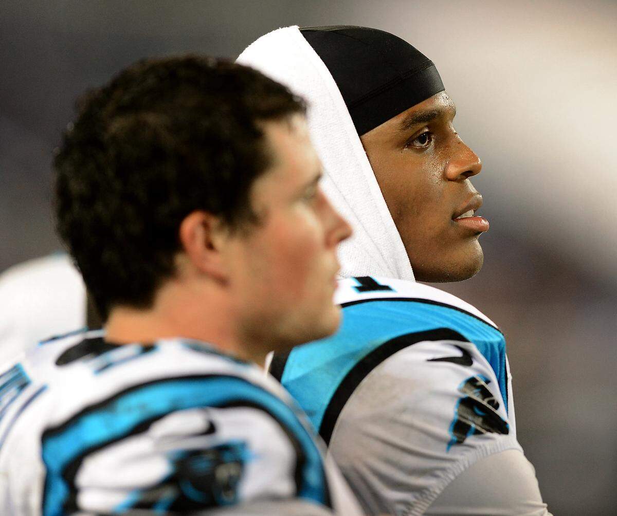 Carolina Panthers quarterback Cam Newton (right) and linebacker Luke Kuechly watch from the sidelines in 2013. Kuechly retired in January, and Newton’s departure also seems imminent.