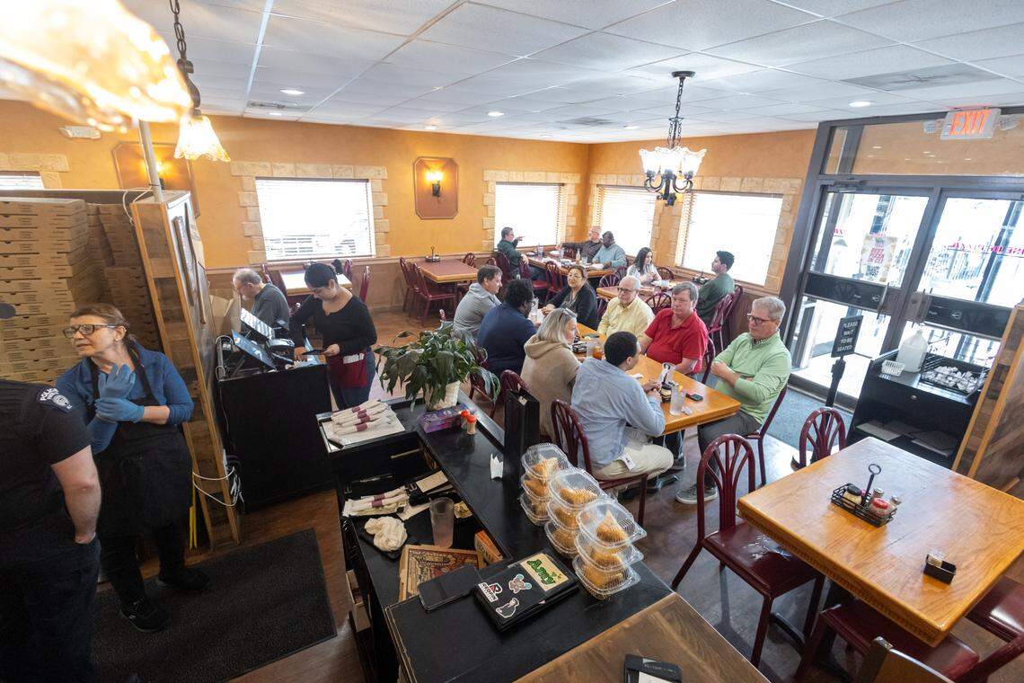 Customers gather to eat inside House of Pizza.