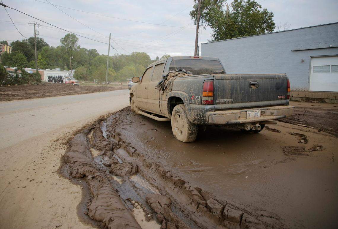 A pickup truck is encased in mud Thursday, Oct. 3, 2024 near downtown Asheville, N.C.