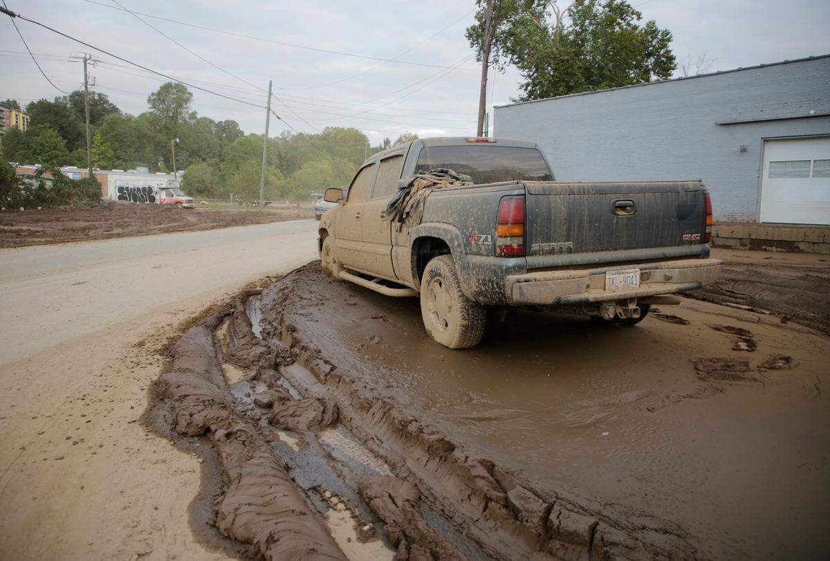 A pickup truck is encased in mud Thursday, Oct. 3, 2024 near downtown Asheville.