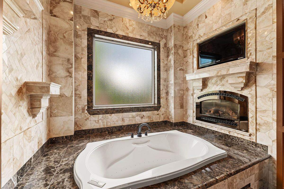 The primary suite features an en-suite bathroom, a private sitting area and a balcony overlooking the grounds.