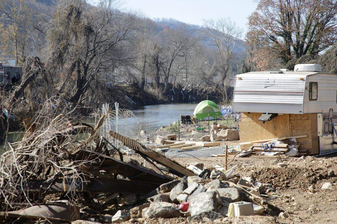 A camper and a tent sit alongside the Swannanoah River Monday in Swannanoah, N.C.