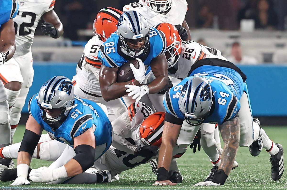 Carolina Panthers tight end James Mitchell, center, dives forward for yardage against the Cleveland Browns on Aug. 8, 2025, at Bank of America Stadium in Charlotte. The Browns defeated the Panthers 30-10.