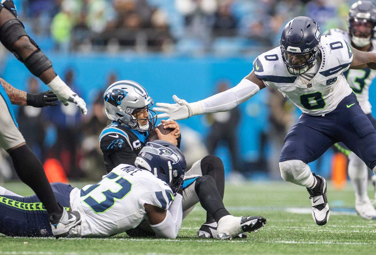 Carolina Panthers quarterback Bryce Young is sacked by Seattle Seahawks linebacker Boye Mafe on Sunday at Bank of America Stadium.