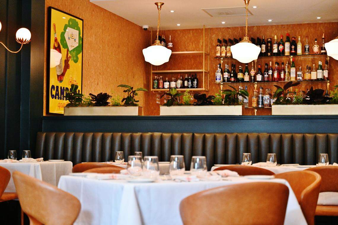 The wall that lines the bar at Aqua e Vino is made of cork and gold leaf from 1940s Spain.