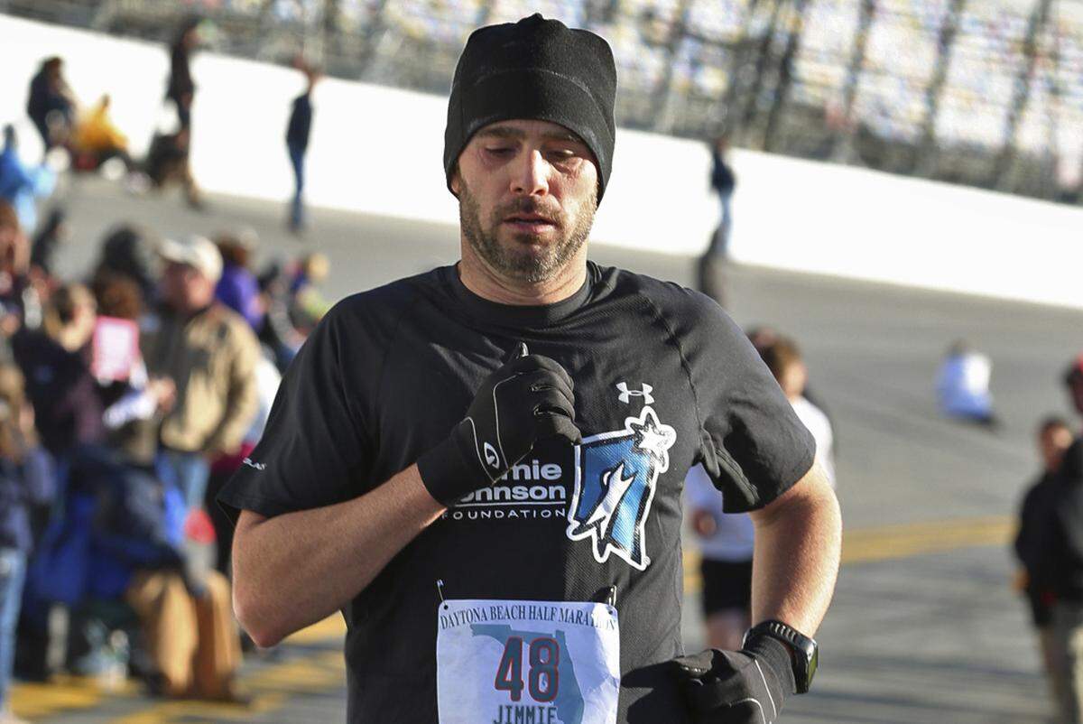 Jimmie Johnson races to the finish line of his first half marathon, in Daytona Beach, Fla., on Feb. 17, 2013.