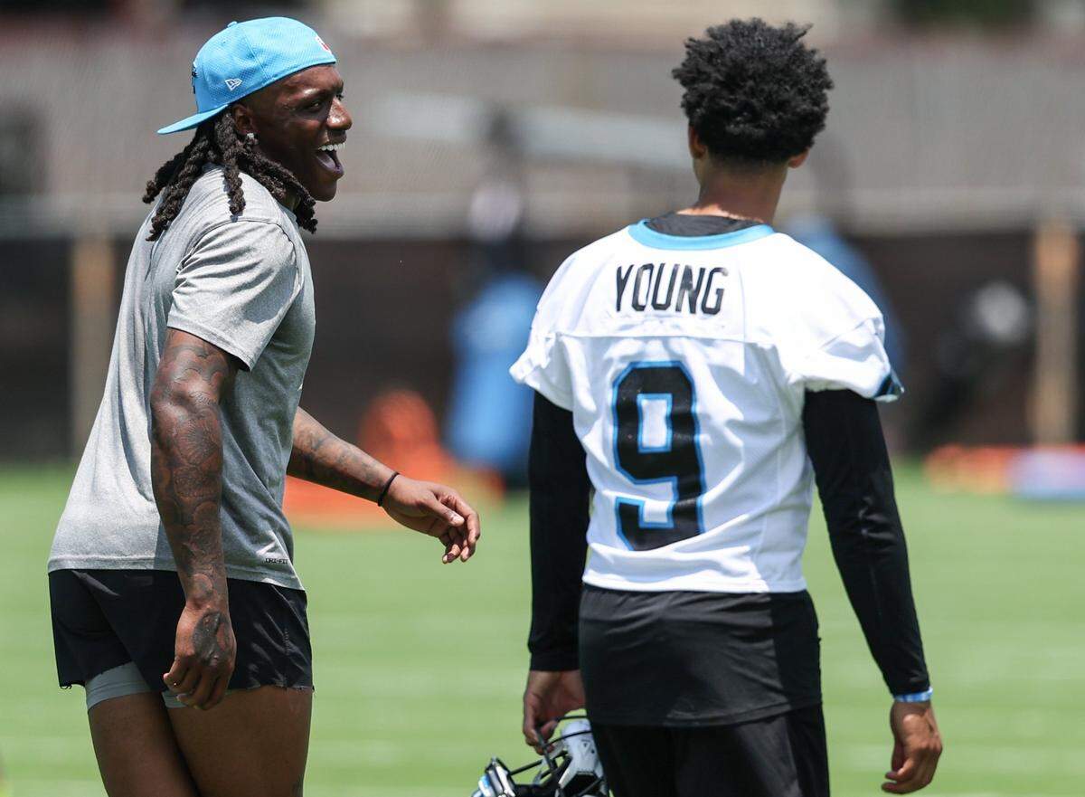 Panthers cornerback Jaycee Horn, left, laughs in response as he and quarterback Bryce Young have a playful exchange during the second day of minicamp in Charlotte, NC on Wednesday, June 11, 2025.
