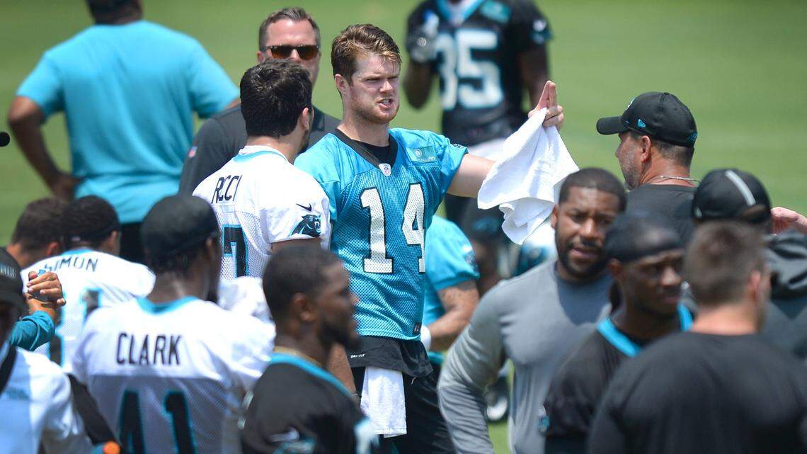 Carolina Panthers quarterback Sam Darnold, center, speaks with a teammate during a break in drills at the team’s OTA practice May 25. Darnold’s success will be key to the Panthers improving from their five wins a year ago.