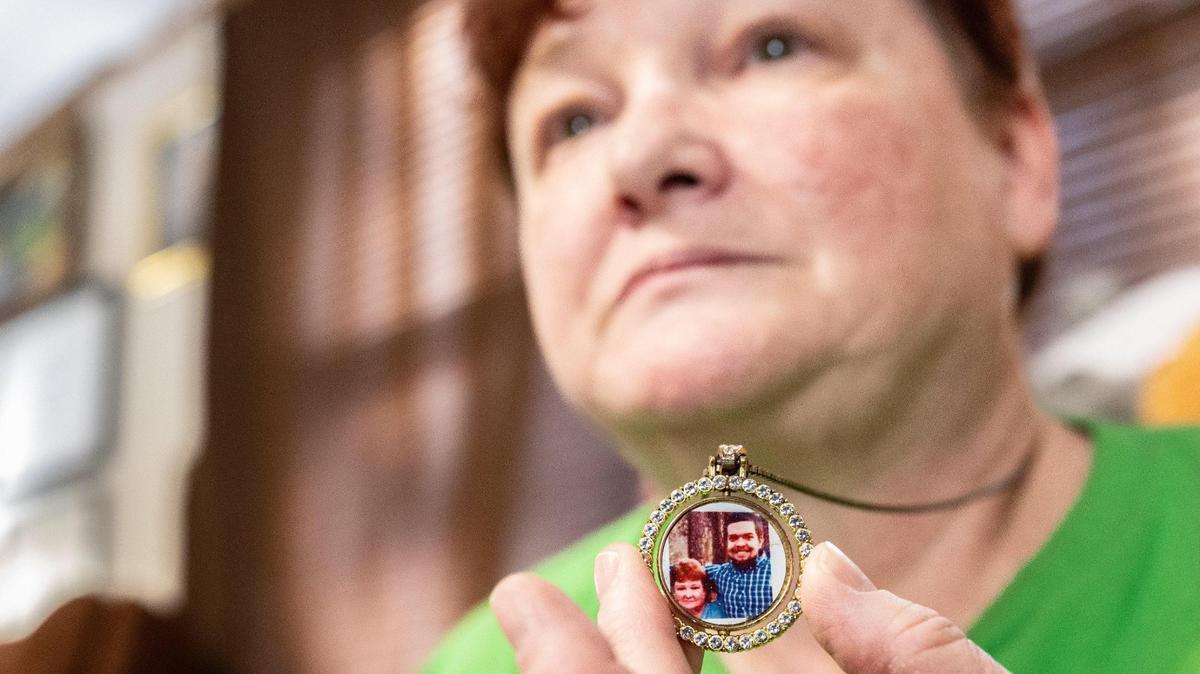 Regina Quick holds a keepsake necklace containing a photo of her stepson, Erik Ramsey at her Troutman, N.C., home on Feb. 3. Ramsey died by suicide while confined inside Harnett Correctional Institution. He had a history of mental health issues.