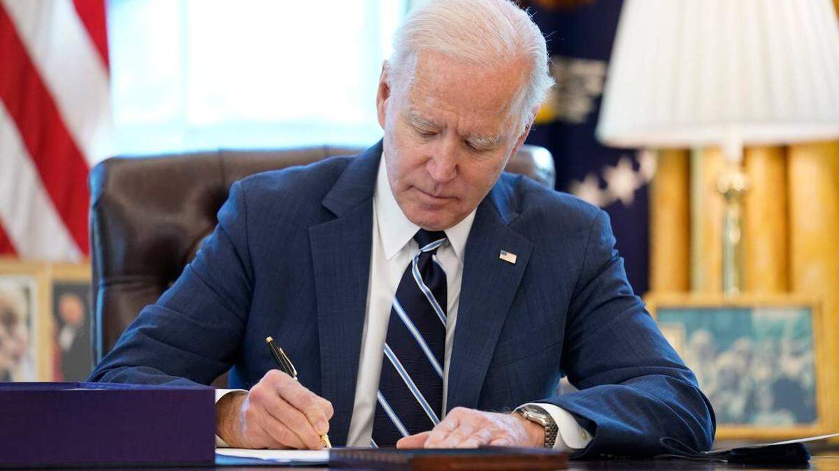 President Joe Biden signs the American Rescue Plan, a $1.9 trillion coronavirus relief package, in the Oval Office at the White House on March 11.