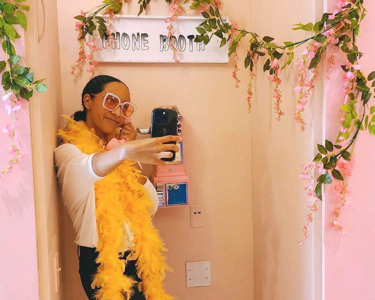 Reporter Chyna Blackmon takes a selfie in one of Portal CLT’s 15 rooms. The reopened selfie museum offers over 100 photo ops for guests.