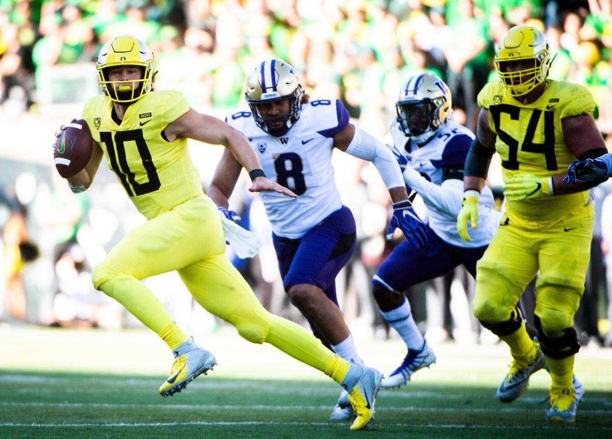 Oregon quarterback Justin Herbert (10) could conceivably be available when the Panthers pick at No. 7 in the first round of the NFL draft on April 23rd.