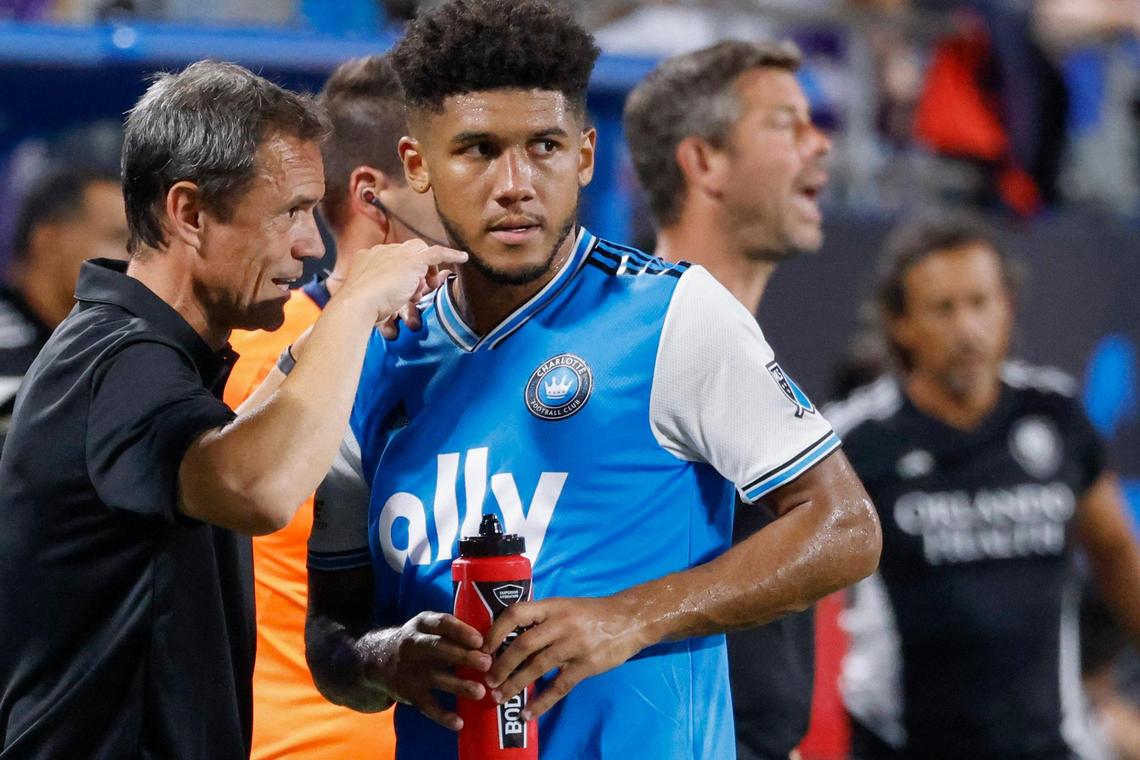 Charlotte FC head coach Christian Lattanzio talks to defender Jaylin Lindsey in the second half against Orlando City in Charlotte, N.C., Sunday, Aug. 21, 2022.