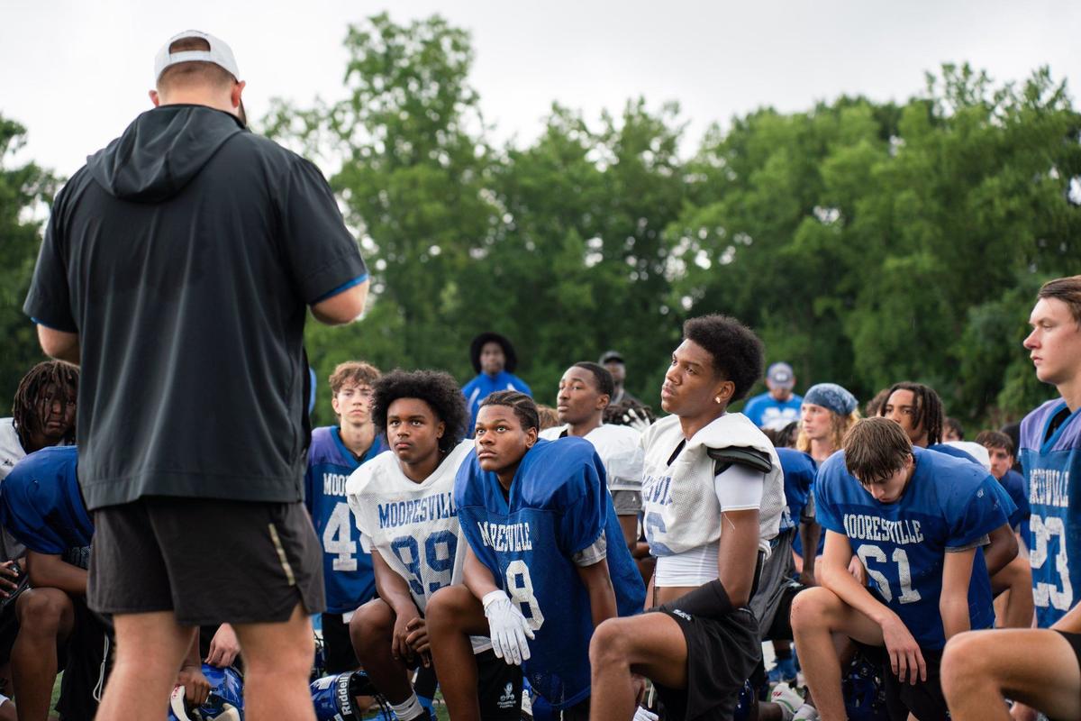 Coach Zach Mayo talking to his team during a morning practice at Coach Joe Popp Stadium on July 25, 2024.
