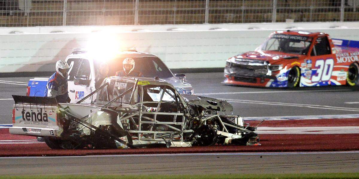 NASCAR Camping World Truck Series driver Johnny Sauter, center, glances back at his truck after being involved in a wreck during the NC Education Lottery 200 at Charlotte Motor Speedway in Concord, NC on Friday, May 28, 2021.