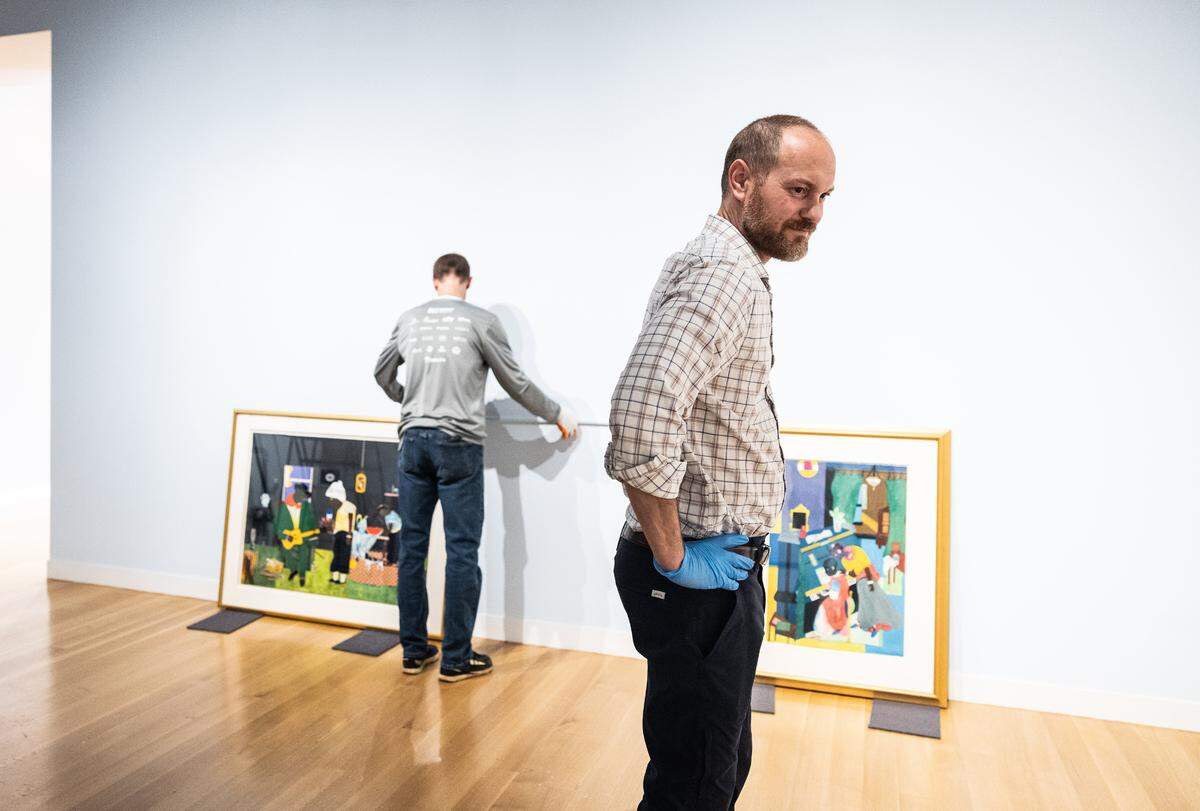 Jonathan Stuhlman, senior curator at The Mint Museum, inspects the gallery where the “Bearden/Picasso: Rhythms and Reverberations” exhibition that he curated is being set up.