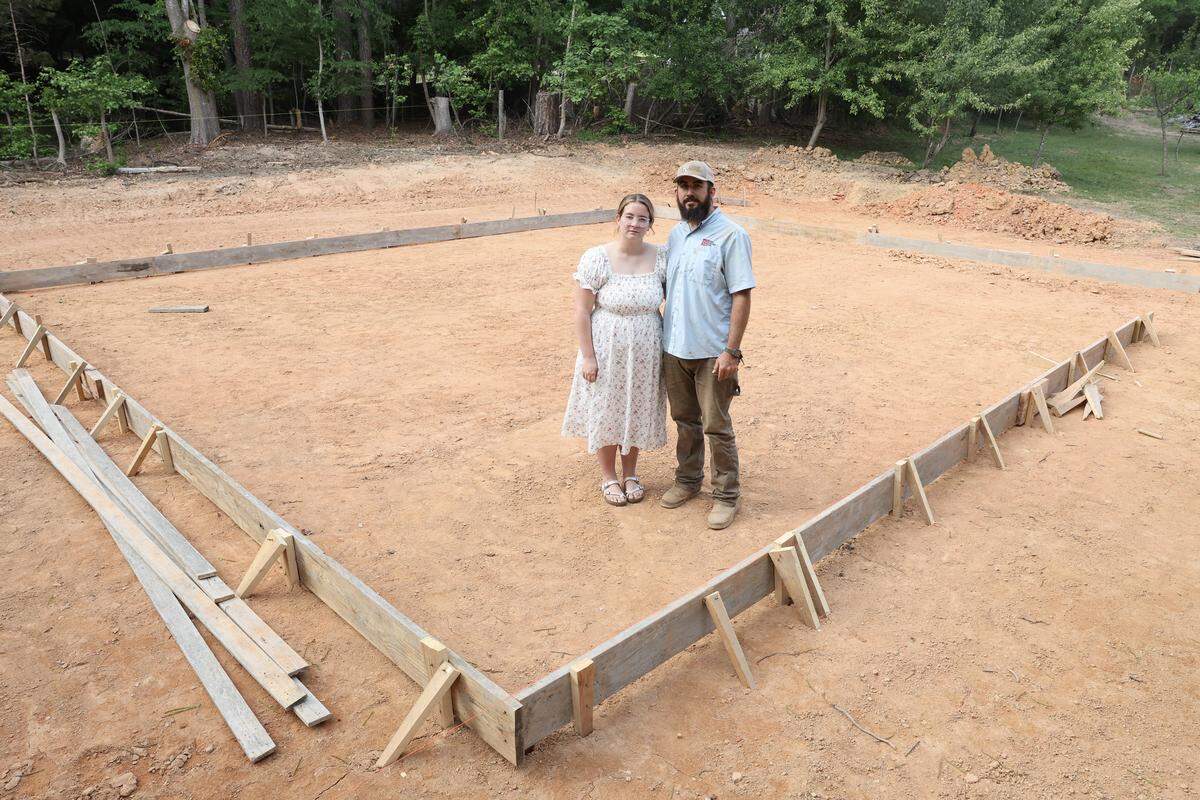 Mary-Kate and Cody Benfield stand in the frame of their future home Wednesday, May 6, 2026 in Fort Mill, S.C. 