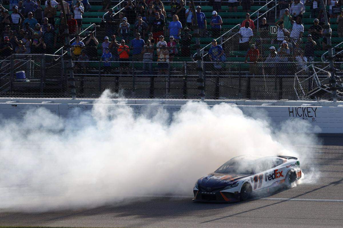 May 7, 2023; Kansas City, Kansas, USA; NASCAR Cup Series driver Denny Hamlin (11) reacts after winning the AdventHealth 400 at Kansas Speedway. Mandatory Credit: Mike Dinovo-USA TODAY Sports