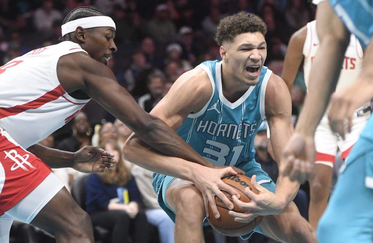 Charlotte Hornets forward Tidjane Salaun (31) gets the ball stripped by Houston Rockets forward Jae’ Sean Tate (8) during the first half at the Spectrum Center.