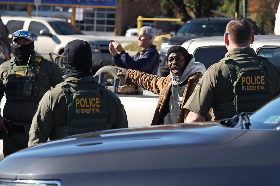 A man confronts U.S. Customs and Border Patrol agents in the parking lot of the Compare Foods on North Tryon St. in Charlotte, NC on Monday, November 17, 2025.