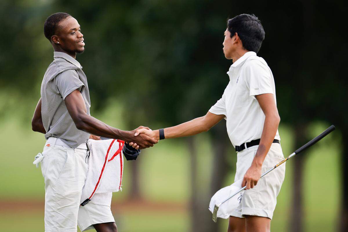 Johnson C. Smith’s Isaiah Nickerson, left, and Alabama State’s Miguel Ilas shake hands after the twelfth hole during the Charlie Sifford Centennial Cup at Quail Hollow Club in Charlotte, N.C., Monday, Aug. 29, 2022.