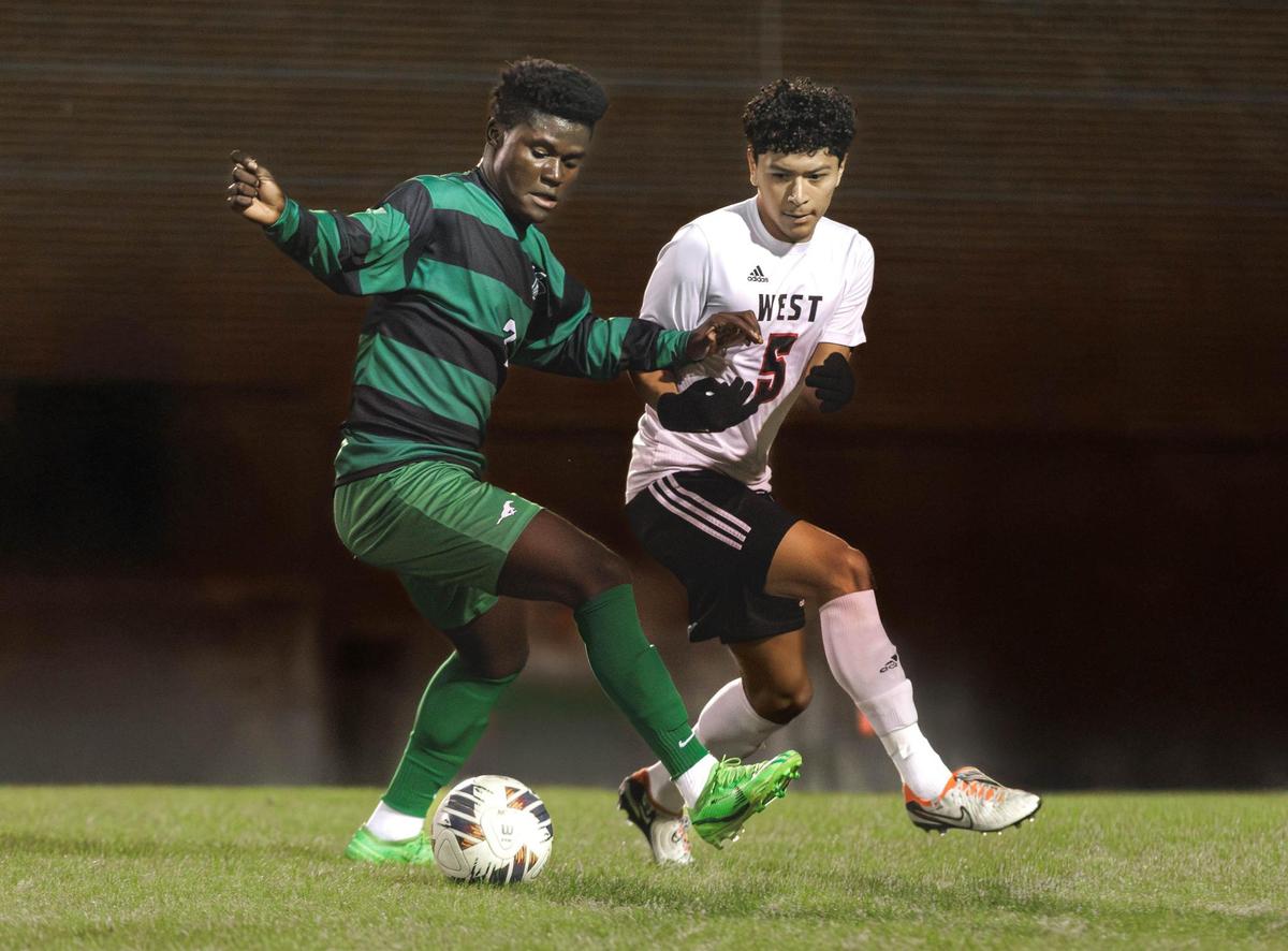 Myers Park’s Nelson Waple (left) battles the Wolverine’s Isidroh Garcia-Salazar (5) for the ball in the mid-field. Myers Park would host West Cabarrus in the 1st round of the NCHSAA high school soccer playoffs Saturday November 9, 2024.