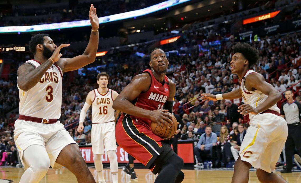 Miami Heat center Bam Adebayo (13) goes to the basket against Cleveland Cavaliers center Andre Drummond (3) and Kevin Porter Jr. (4) in February 2020. The Cavs have a lot of centers on roster and the Hornets need help at that position.