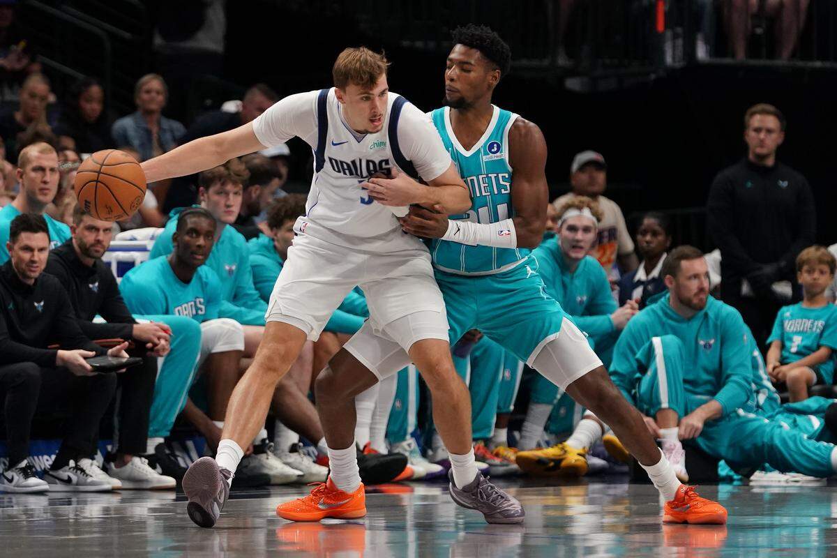 Dallas Mavericks forward Cooper Flagg (32) works on Charlotte Hornets forward Brandon Miller (24) in the first half of Saturday’s game at American Airlines Center. 