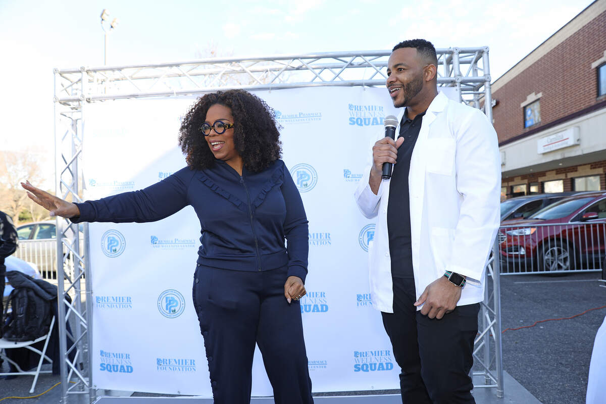 Oprah Winfrey with Premier Pharmacy’s Martez Prince on Friday in Charlotte.