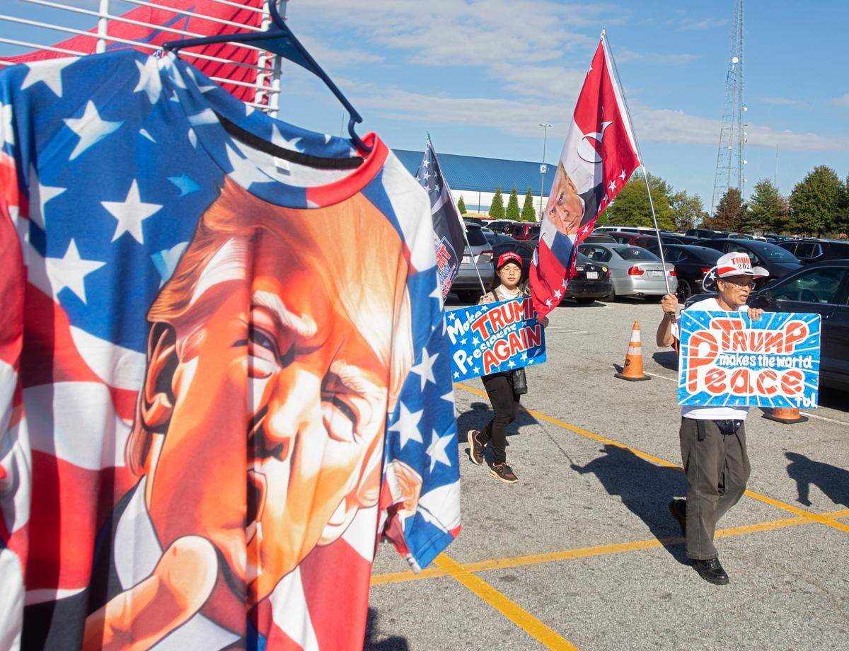 Supporters of former President and Republican presidential candidate Donald Trump gather outside First Horizon Coliseum prior to a campaign rally in Greensboro, N.C. on Saturday, Nov. 2, 2024.