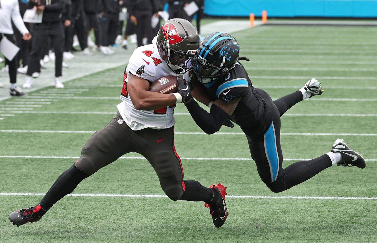 Carolina Panthers cornerback Jaycee Horn, right, wraps up Tampa Bay Buccaneers running back Sean Tucker, left, on a run during action on Dec. 21, 2025, at Bank of America Stadium. The Panthers defeated the Buccaneers 23-20.