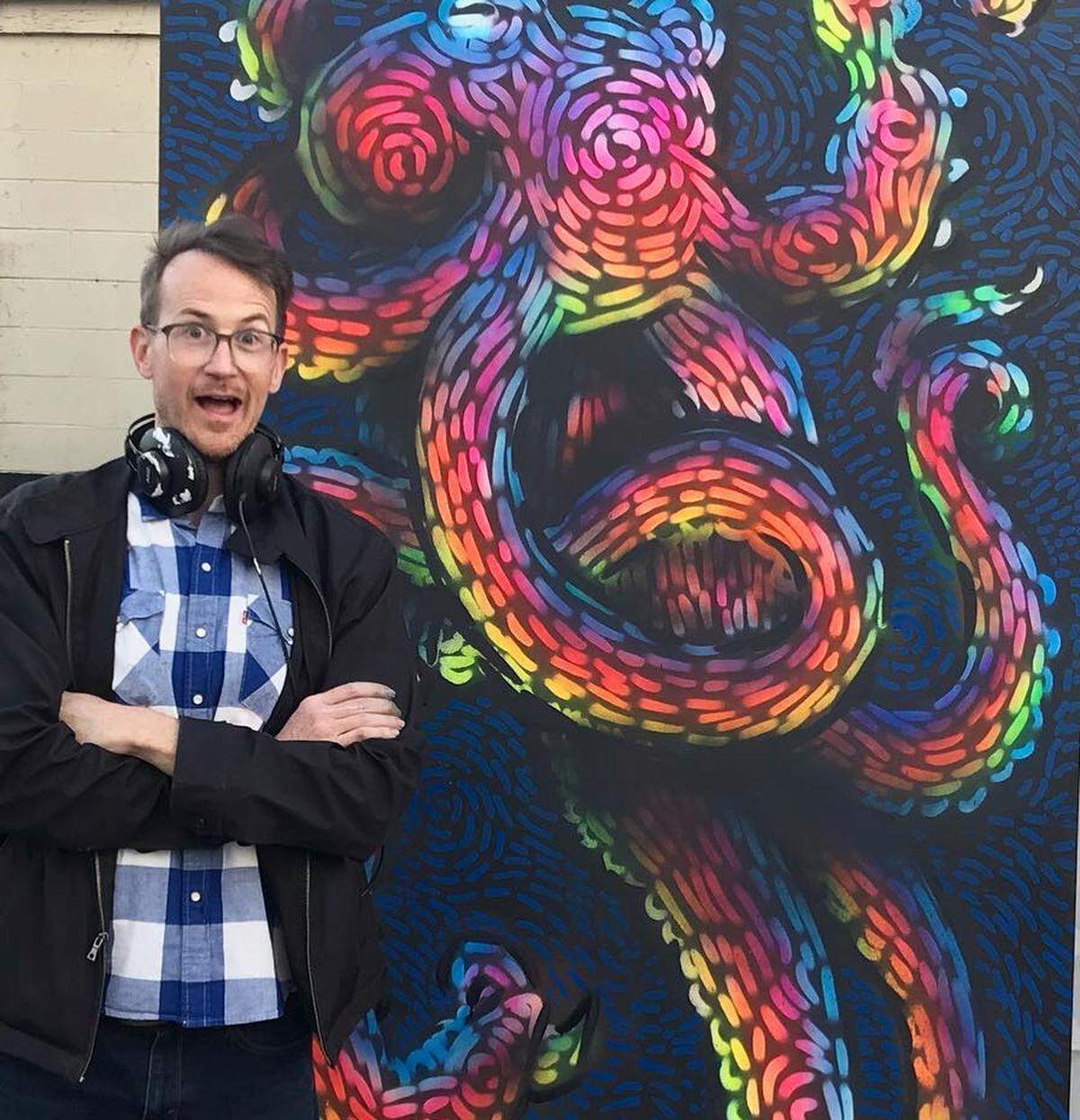 Mike Wirth stands next to “Electro Octo”, a piece he painted at Blind Pig Live Paint Event in NoDa earlier this year.