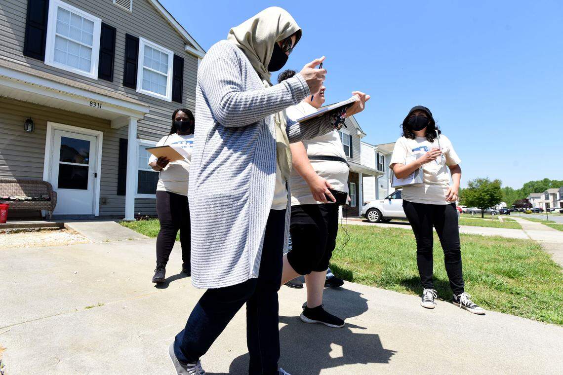 Jessica Moreno, Housing Justice Organizer, Action NC, second from right, and her team of volunteers canvass a neighborhood in Charlotte on Saturday April 23, 2022. Action NC is working to add tenants of corporate landlords to a national tenants union. In the picture are Canvasser Christina Martin del Campo, the canvasser, right, volunteer Azma Shahid, left front, and volunteer Pattache Roper, back left.