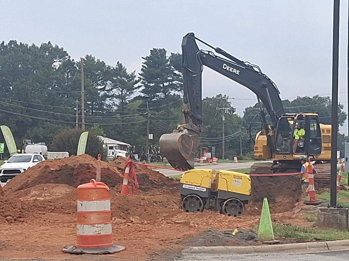 Crews with Charlotte-based Lane Construction Corp. work along U.S. 21 near Brawley School Road/West Wilson Avenue on Saturday, Sept. 6, 2025, as part of the road’s widening. West Wilson reopened on Monday, Dec. 8, 2025.