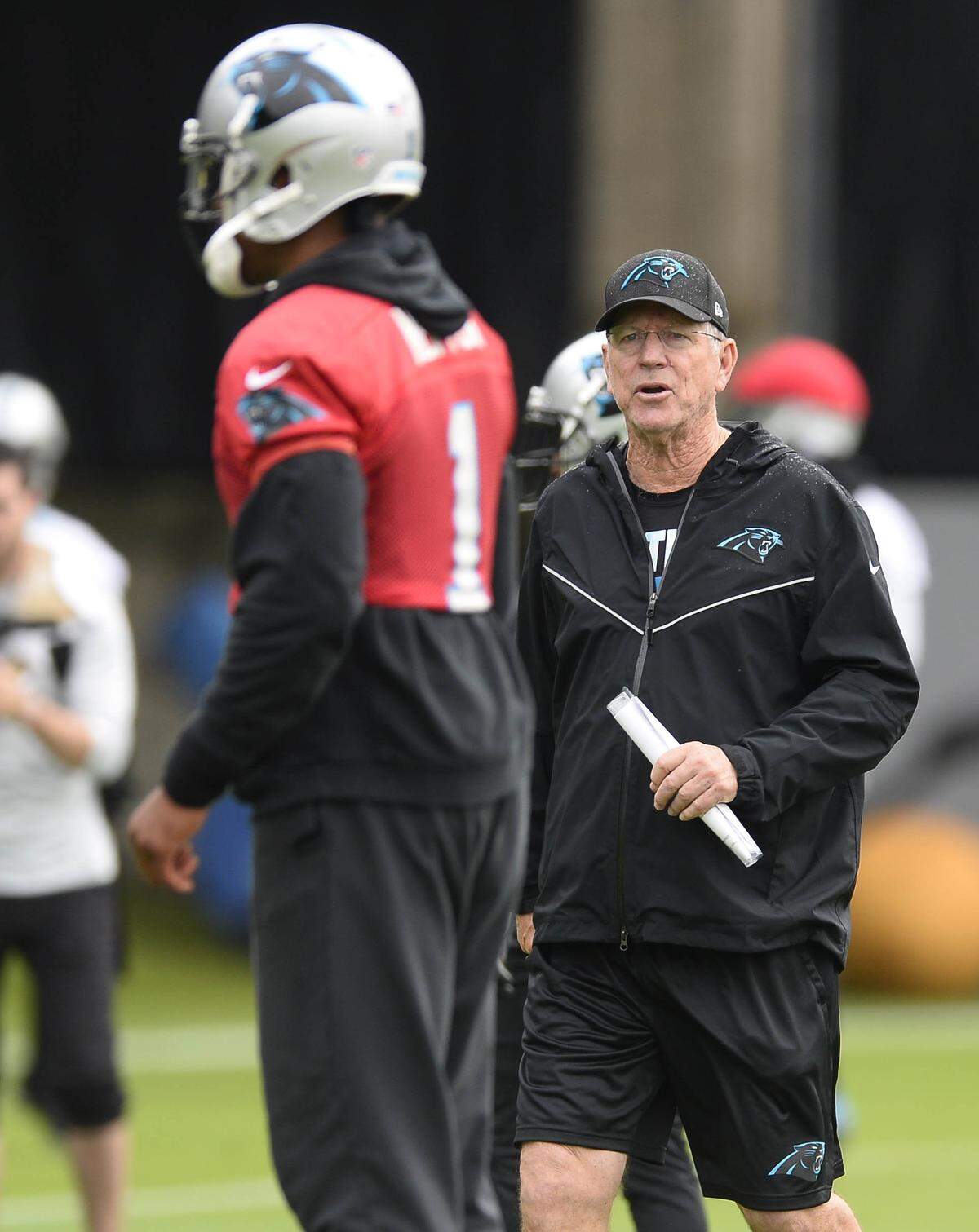Carolina Panthers offensive coordinator Norv Turner instructs quarterback Cam Newton (1) as he prepares to run a play. The team is installing Turner's offense, which is similar to what they've run in the past.