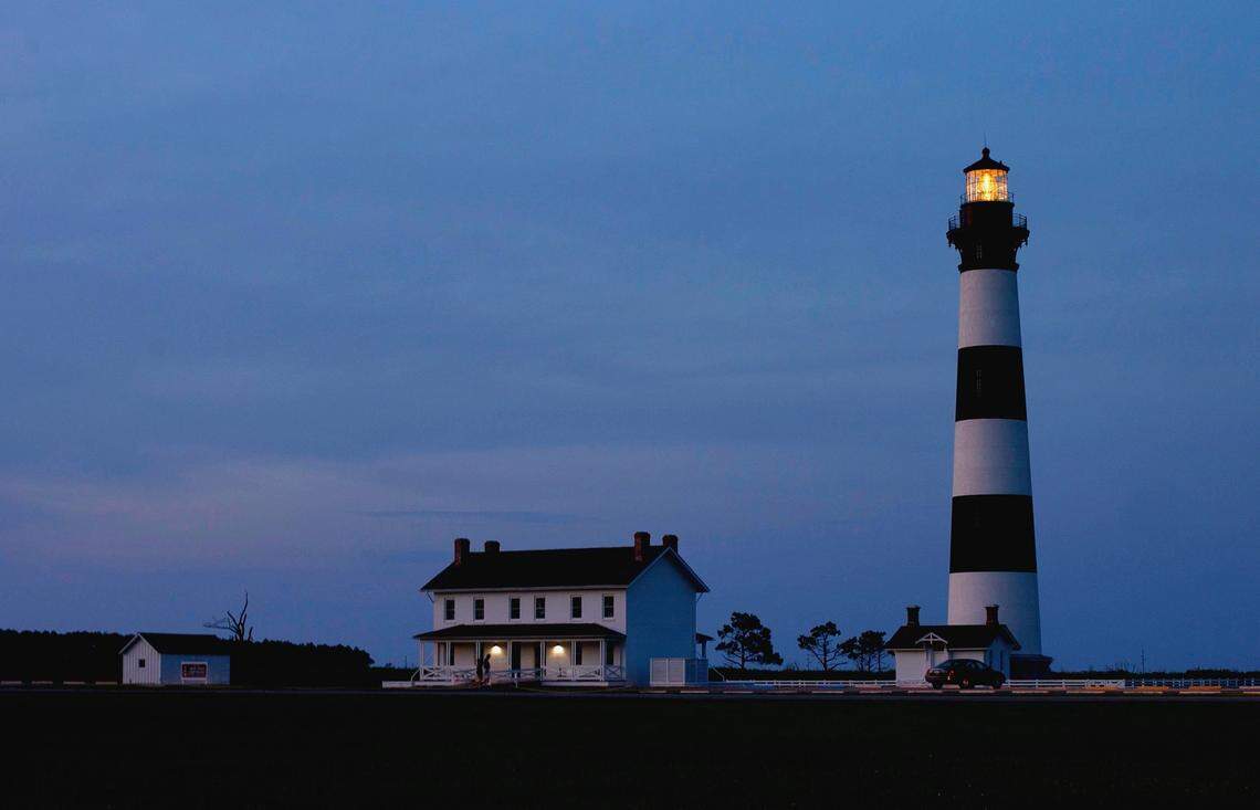 The Bode Island Lighthouse is illuminated as dusk falls on Monday, June 15, 2015 at the Cape Hatteras National Seashore on the outer banks of North Carolina. A National Seashore visitor found a body floating at the south end of Hatteras Island on Friday night, May 28, 2021. 