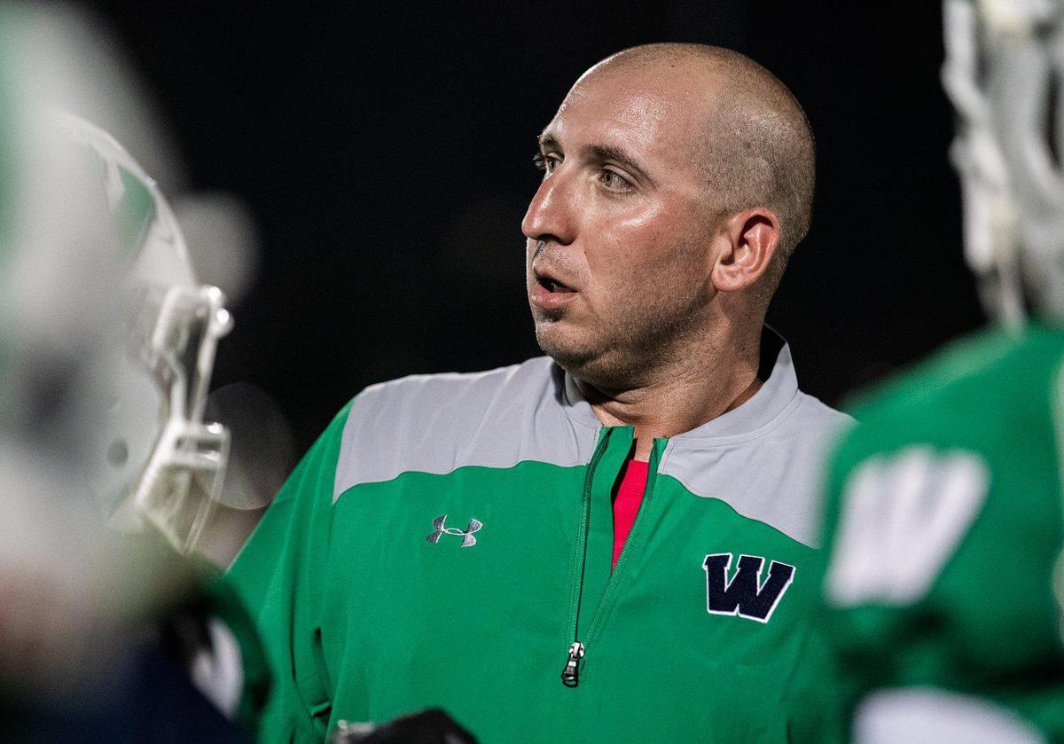 Weddington head coach Andy Capone gathers his team during a third-quarter timeout.