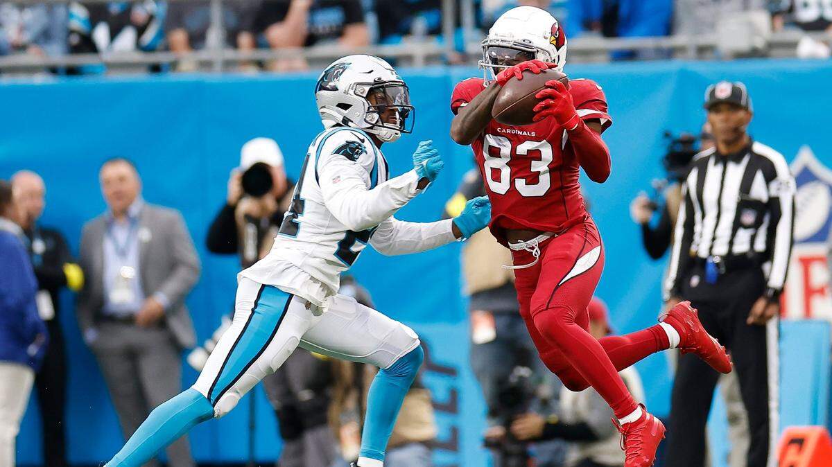 Arizona Cardinals wide receiver Greg Dortch (83) completes a pass with pressure from Carolina Panthers cornerback CJ Henderson (24) during a game at Bank of America Stadium in Charlotte, N.C., Sunday, Oct. 2, 2022.